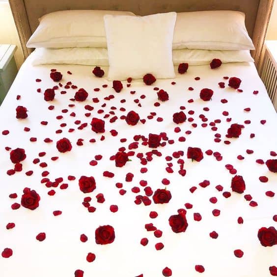 bed decoration with red rose petals 