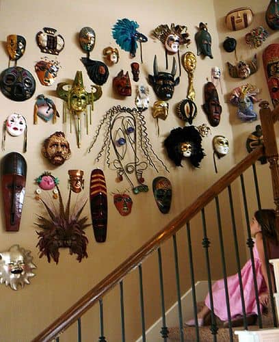 masks hanging on staircase wall