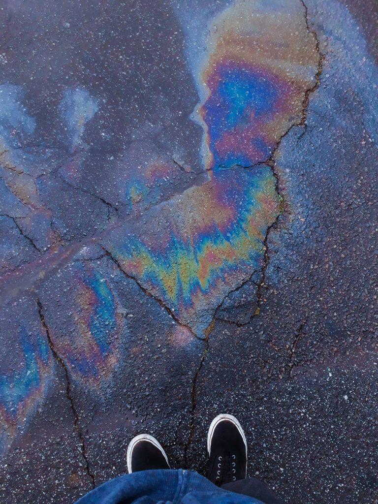 oil spills on a cracked driveway